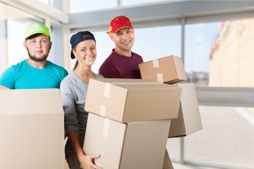 Organised moving day with labelled boxes and wrapped furniture in Aldersbrook